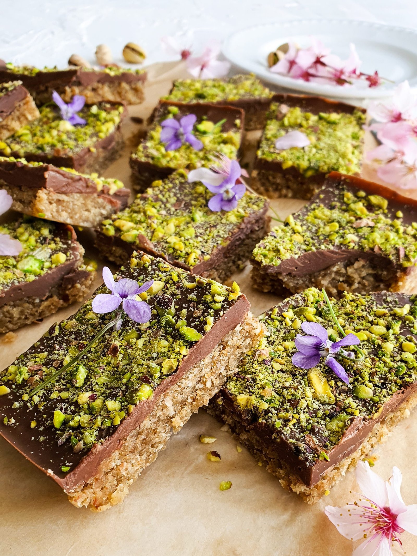 A tray of chewy, nutty bars made with wholesome ingredients, including tahini, sweet dates, crunchy pistachios, and a hint of vanilla. Perfect for a healthy snack.