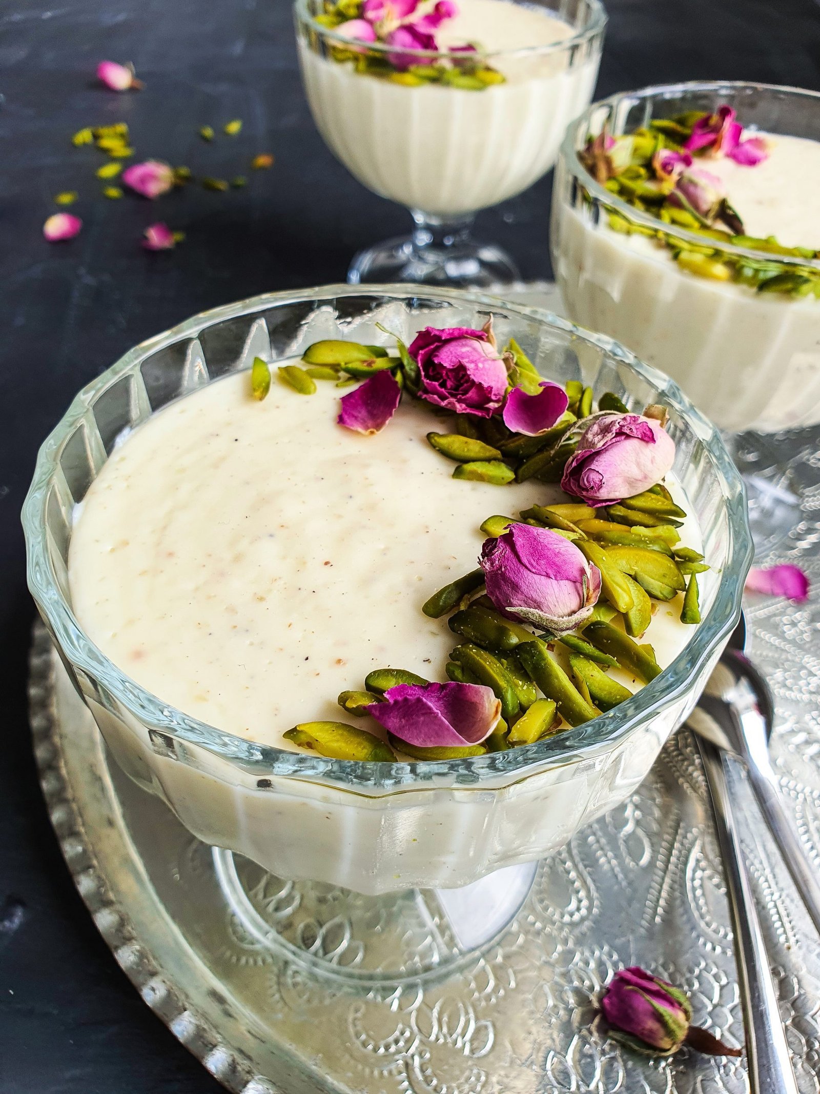 Several small serving dishes filled with chilled and creamy Muhallebi (Muhalabia) Middle Eastern Milk Pudding. 