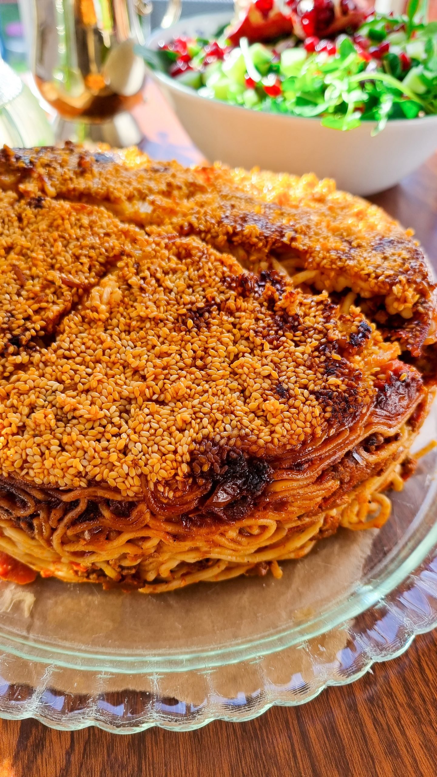 The finished tahdig, a crispy and golden crust, being served with the macaroni