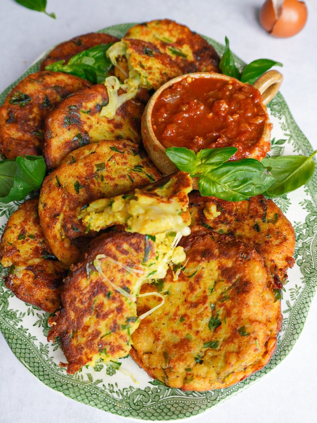 A plate of potato patties with ketchup ready to be served