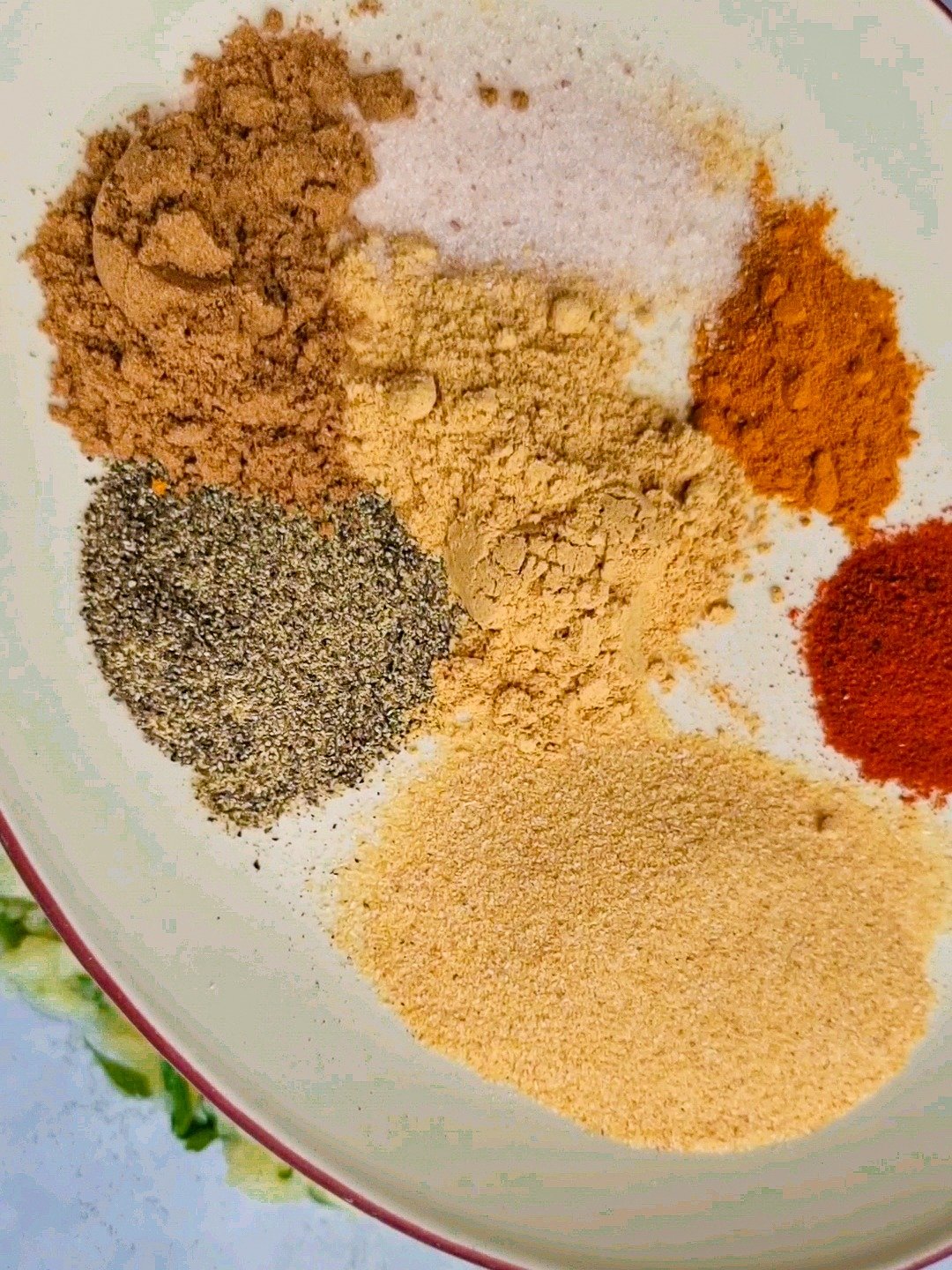 The seasoning for potato patties: salt, turmeric, paprika, garlic powder, black pepper, coriander powder, and ginger powder