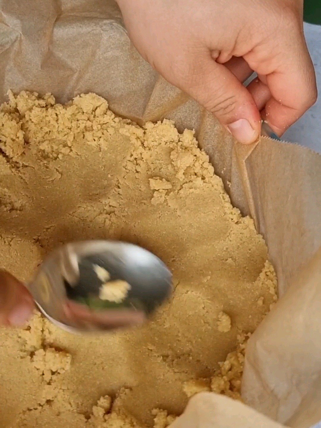 Pressing the almond flour mix in a baking tray