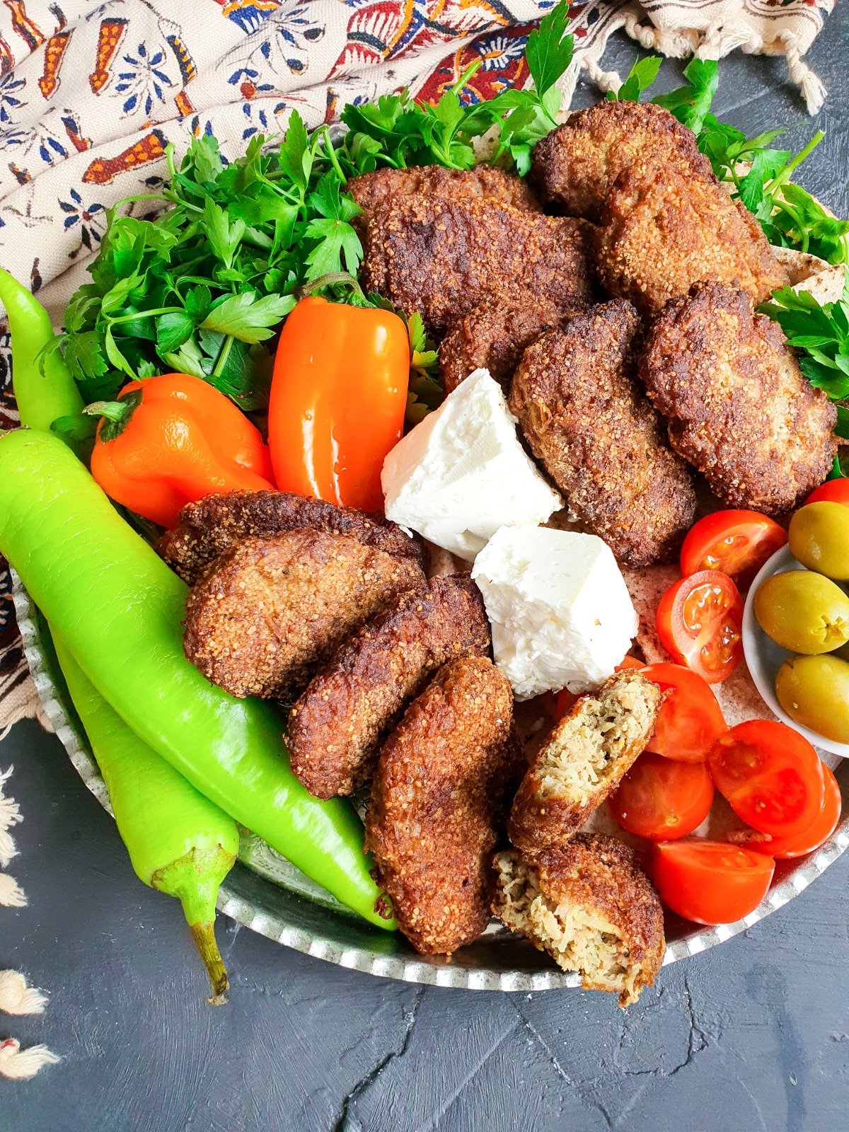 Enjoy your Persian meat kotlets with chunks of white cheese along with home made chips, bread, and lots of salads.