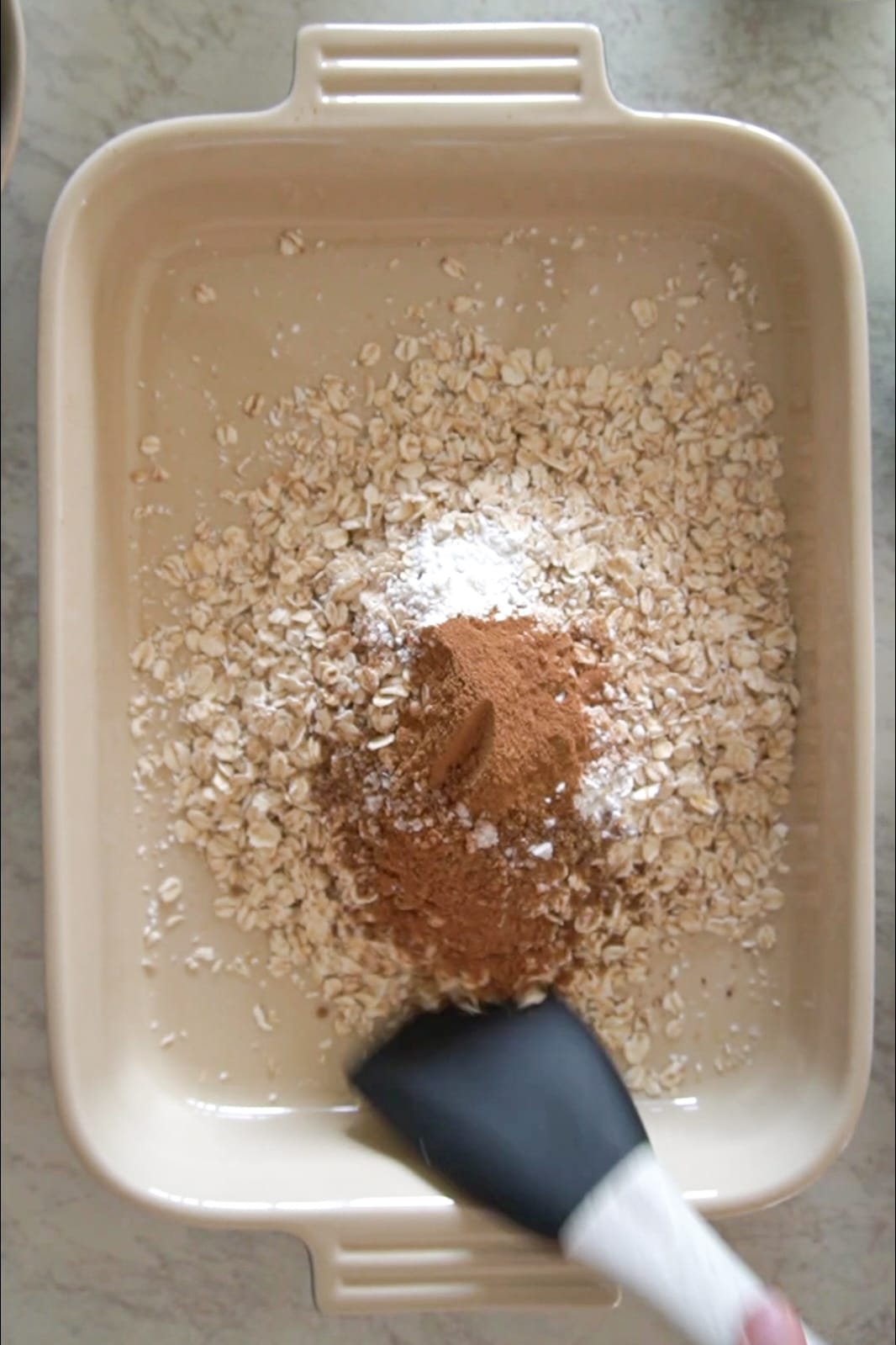 Start, by mixing your dry ingredients in the dish you will bake in.  Your dry ingredients are the oats, cinnamon, nutmeg, salt, ground flaxseed, and baking powder.