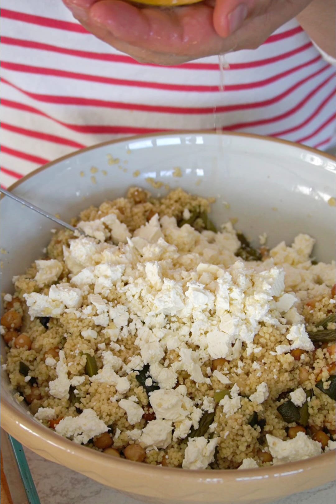 Roasted vegetables couscous salad topped with feta cheese