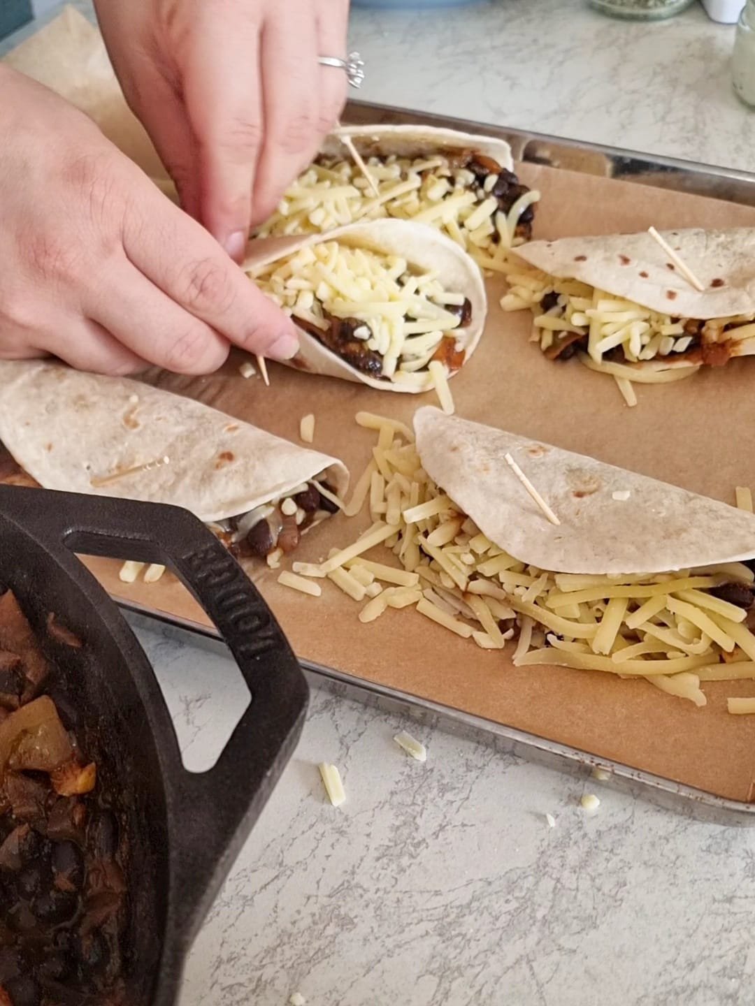 Fill the tacos with 2 tablespoons to mixture each.  Fill the remaining space with cheddar and fold them over. 