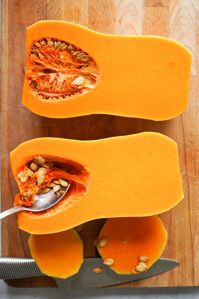 First, start by peeling your butternut squash and cutting into half length ways.  Scoop out the seeds and put aside. Preheat your oven to 200 degrees. 