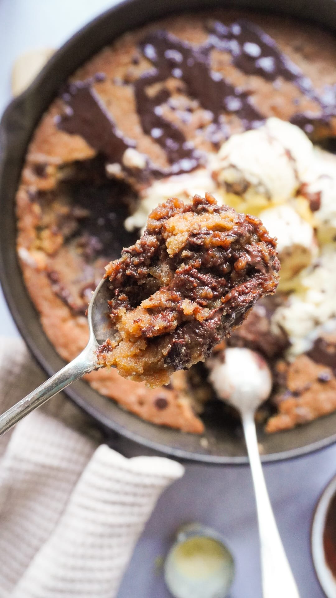 Cookie Dough with chocolate drizzled on top served with a ball of ice cream