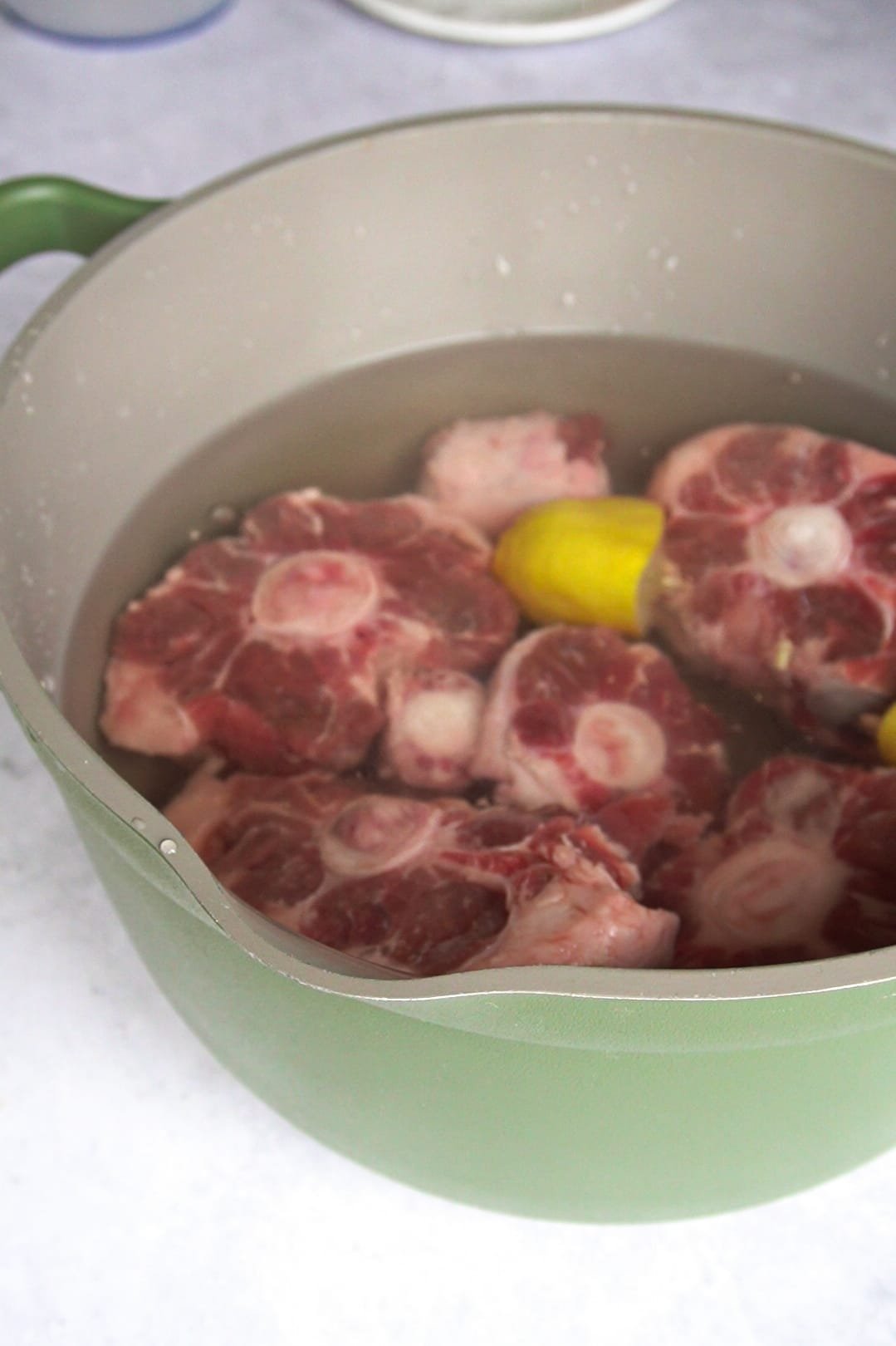 Salt your meat generously for your Simple Homemade Oxtail Soup and add lemons to cleanse it well. 