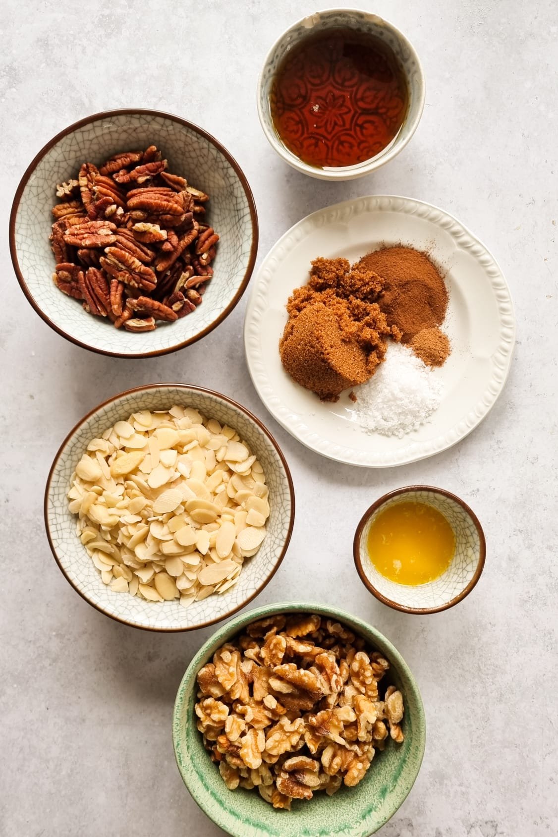 All the ingredients of the Sweet Candied Nuts are well prepared each in its own bowl or plate.