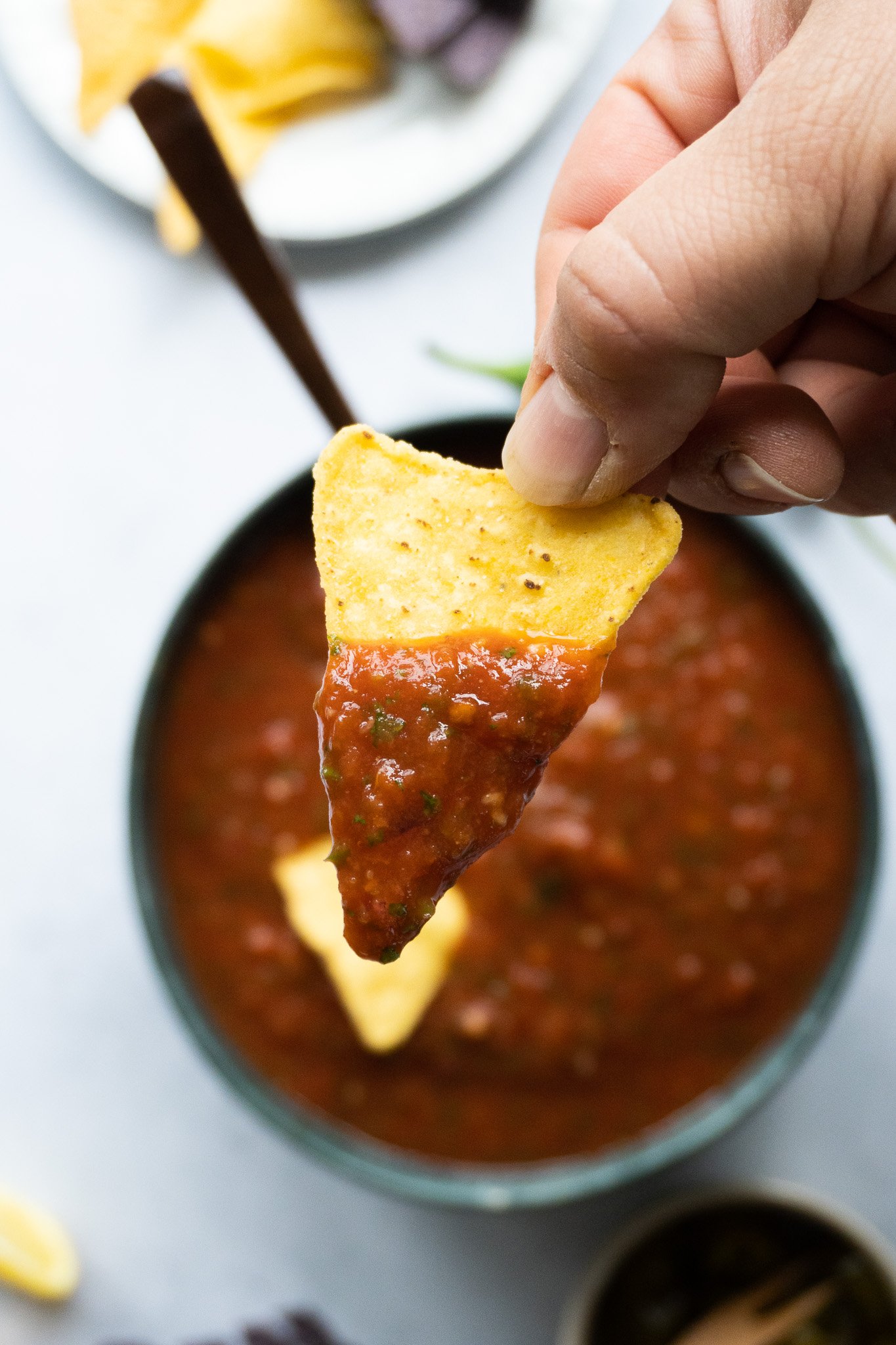 a totilla dipped into fresh homemade salsa, which complements the nacho cheese sauce perfectly 
