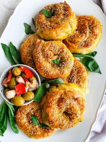 A delicious and savory Turkish pastry filled with cheese and spinach, baked to perfection in a flaky pastry crust.