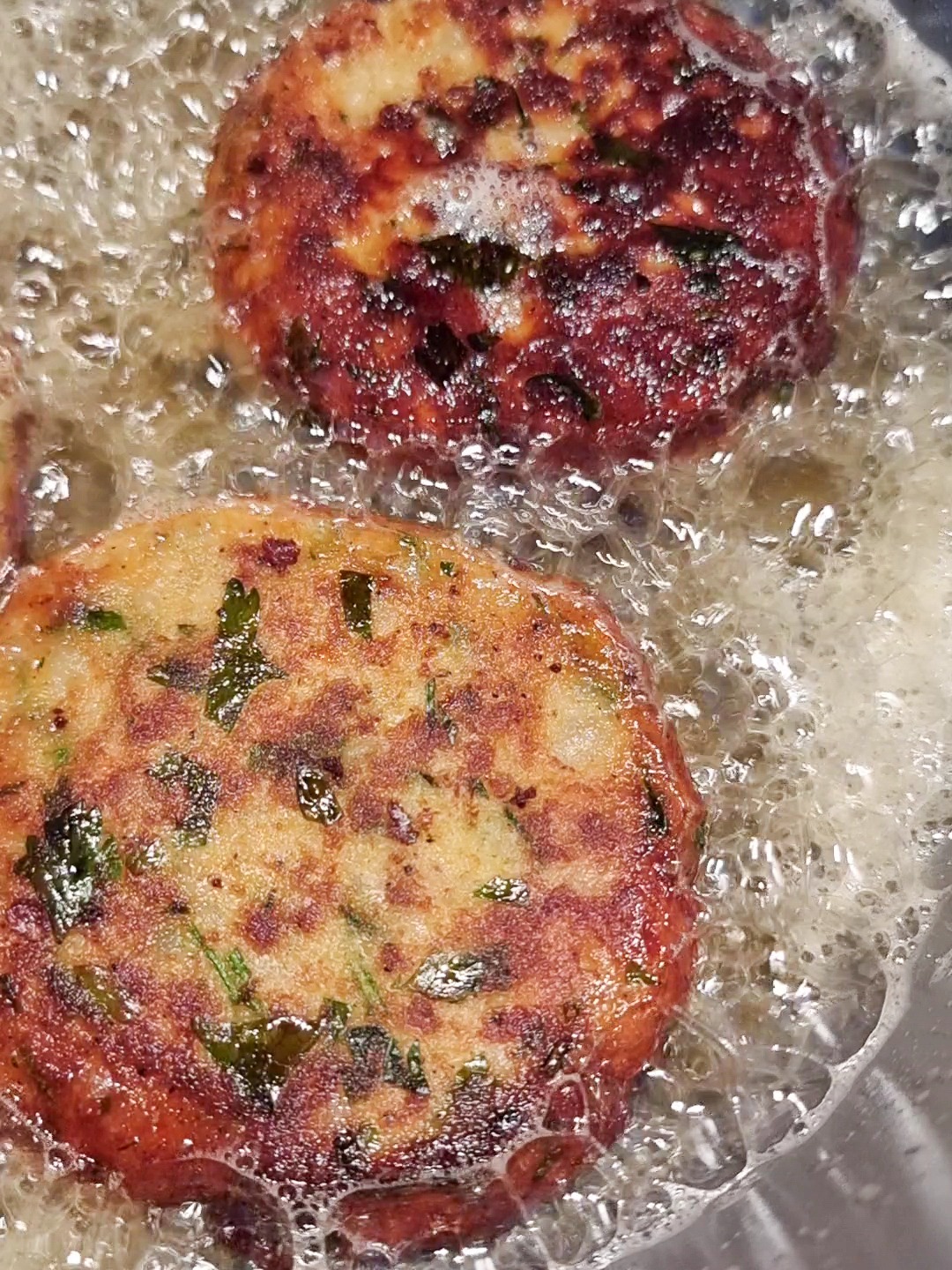 Shallow frying potato patties until golden