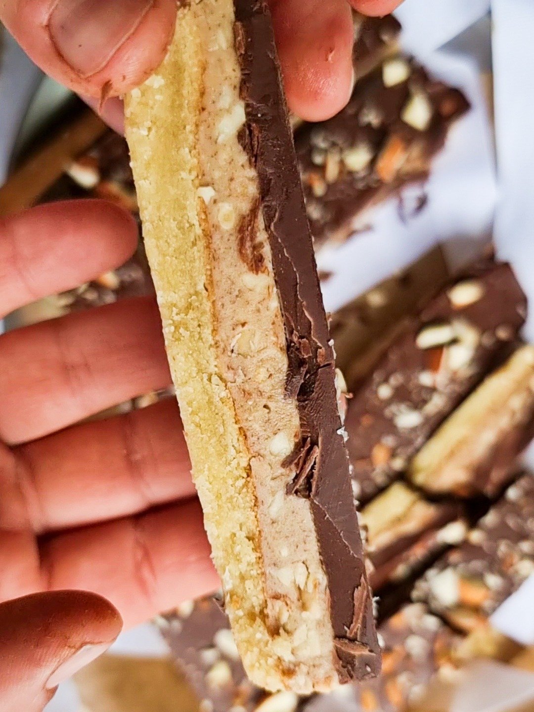 Homemade Gluten-Free Reese’s Peanut Butter Bars made of three layers: almond flour and sweetener, peanut butter, and chocolate are perfect to indulge your dear ones.