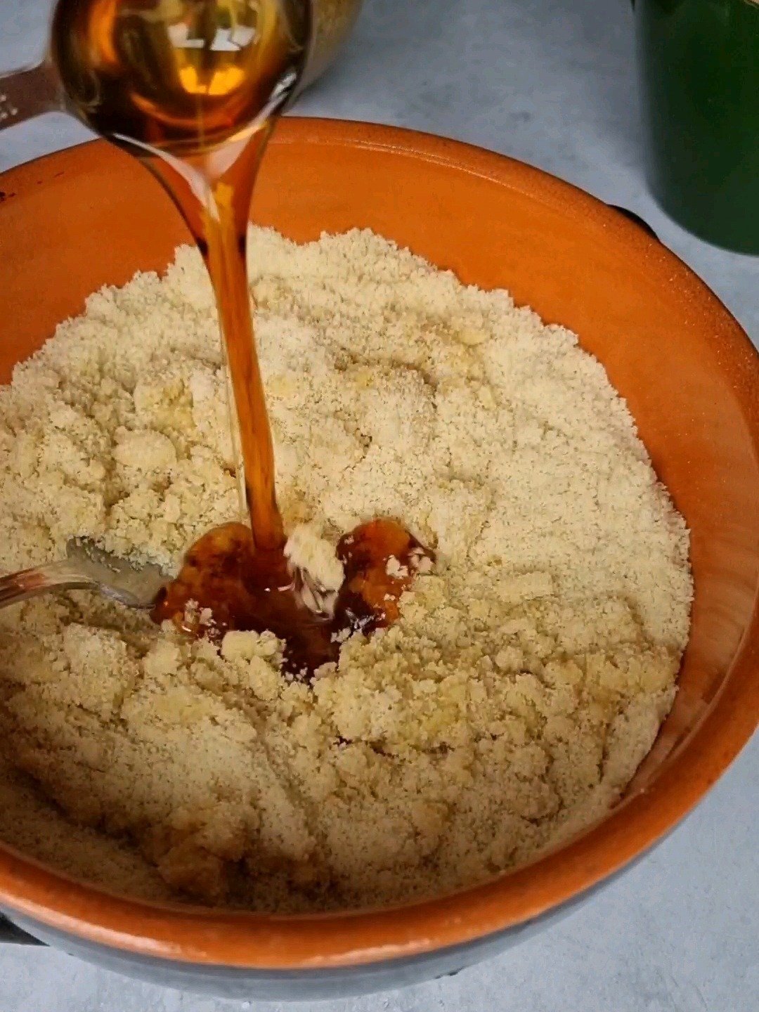 Add maple syrup to almond flour.