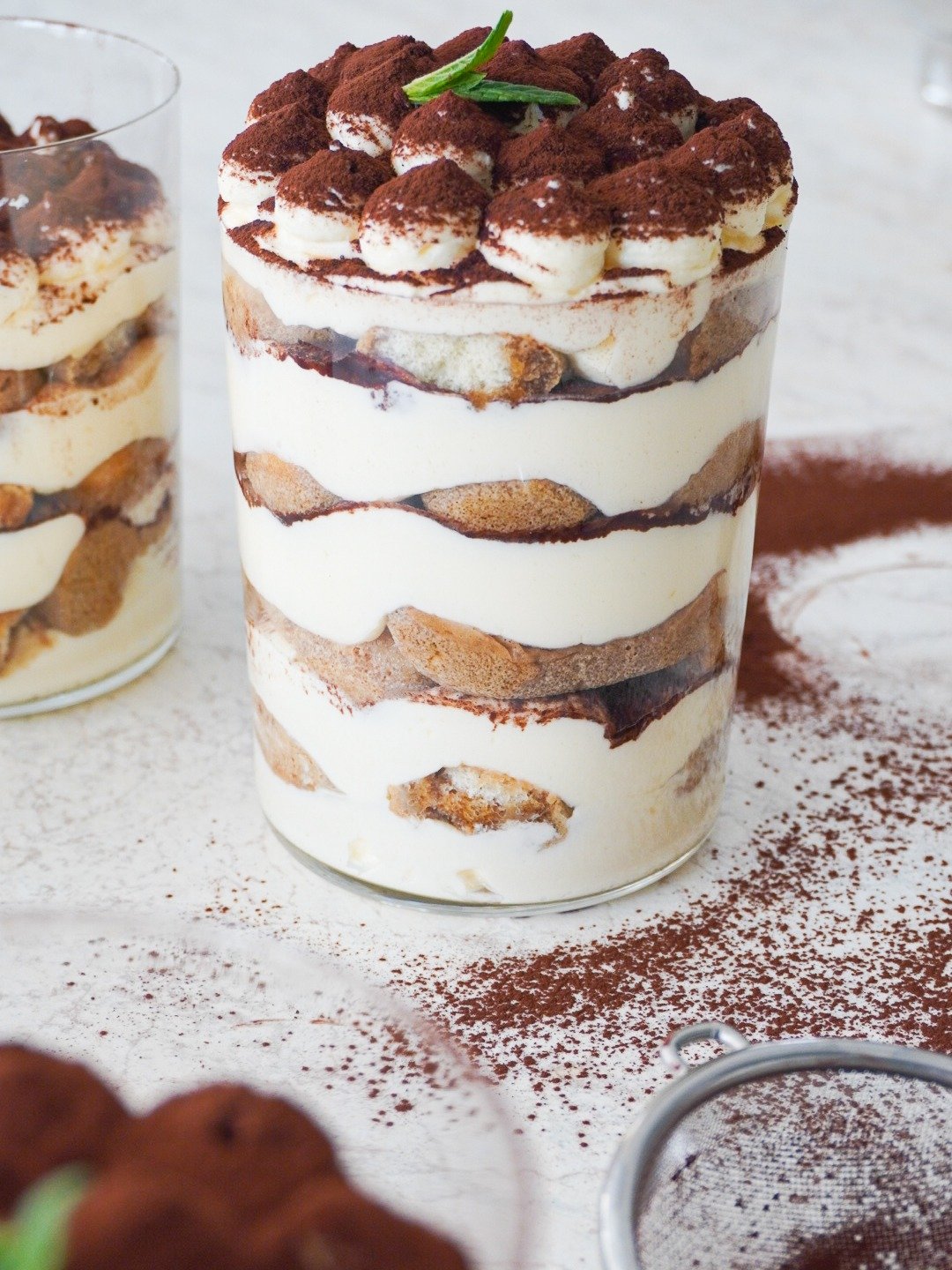 A cup of perfectly layered Tiramisu cups that is ready to go to your fridge and be served later