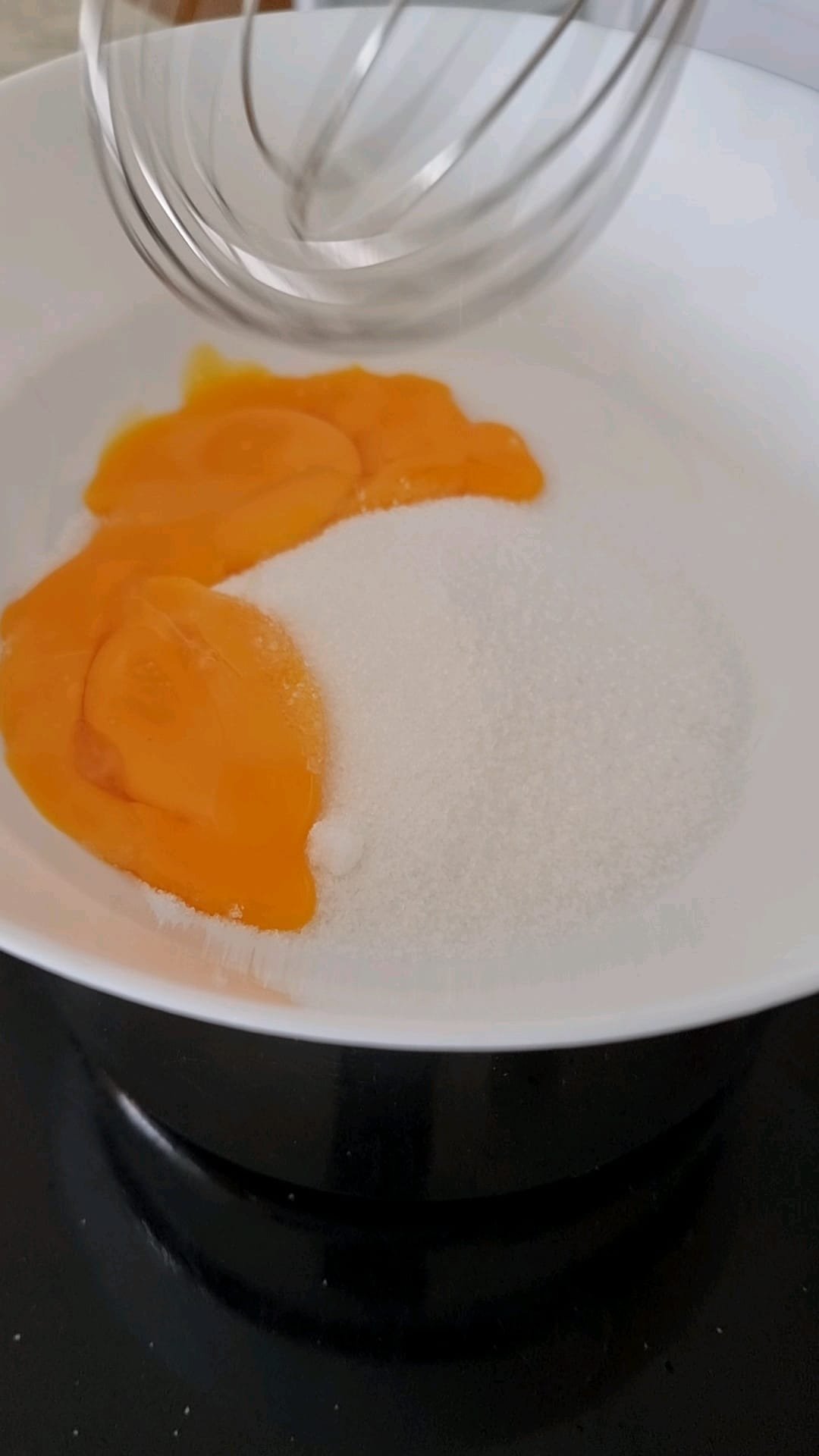 Egg yolks and sugar whisked together in Bain Marie