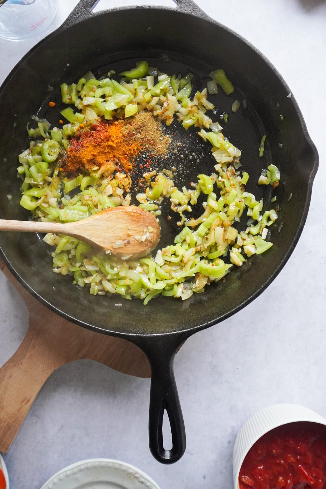 Start by heating your olive oil in a large pan and place your finely chopped onions to sauté until translucent.  Add the chopped Turkish peppers and garlic and continue to sauté for a couple of minutes. Then, add all your spices to the mixture.