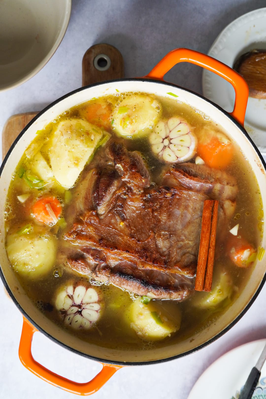 beef, garlic, carrots potatoes and cinnamon put together in a pot to cook