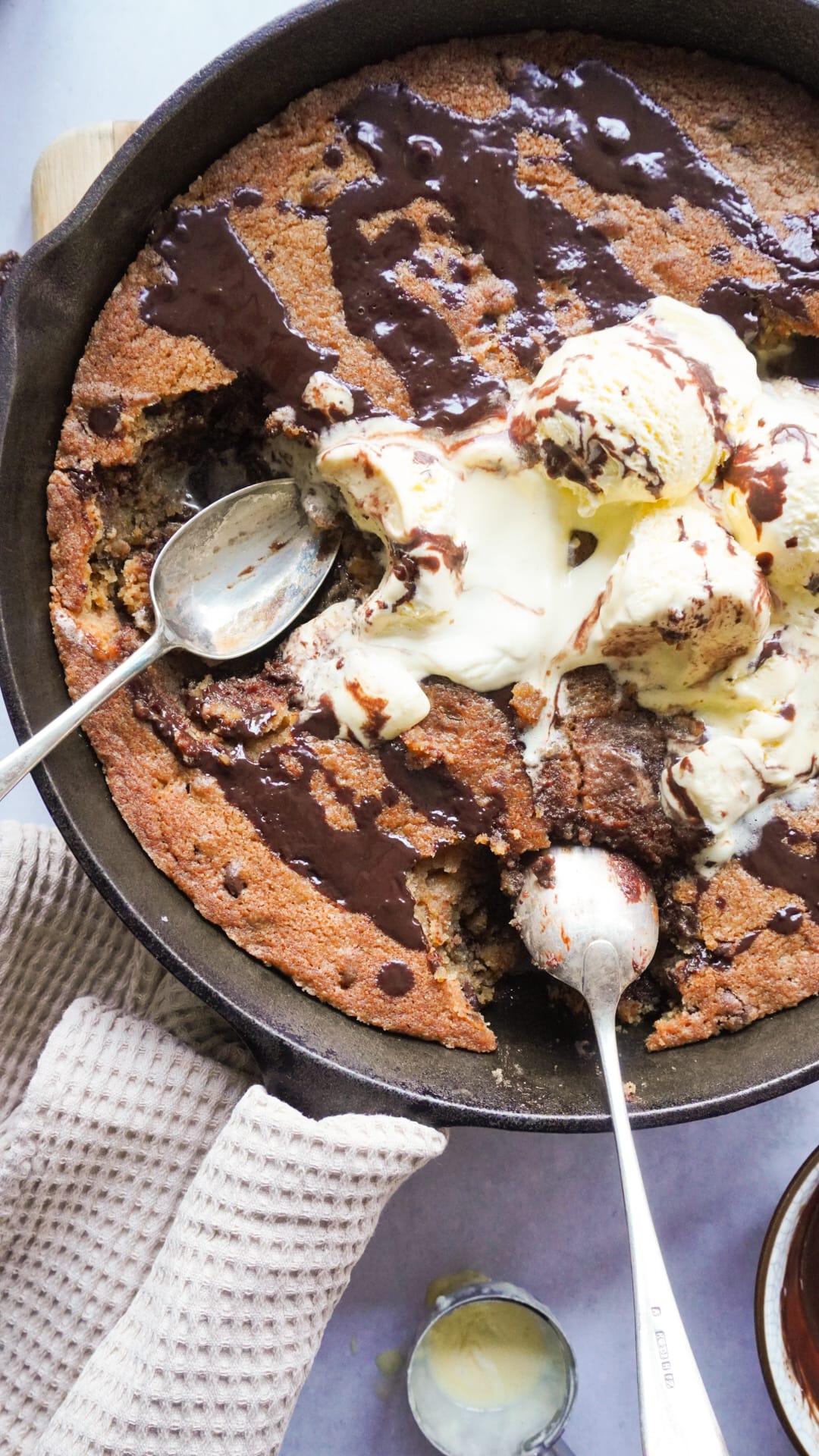 Soft cookie dough served with scoop of vanilla ice cream and chocolate sauce