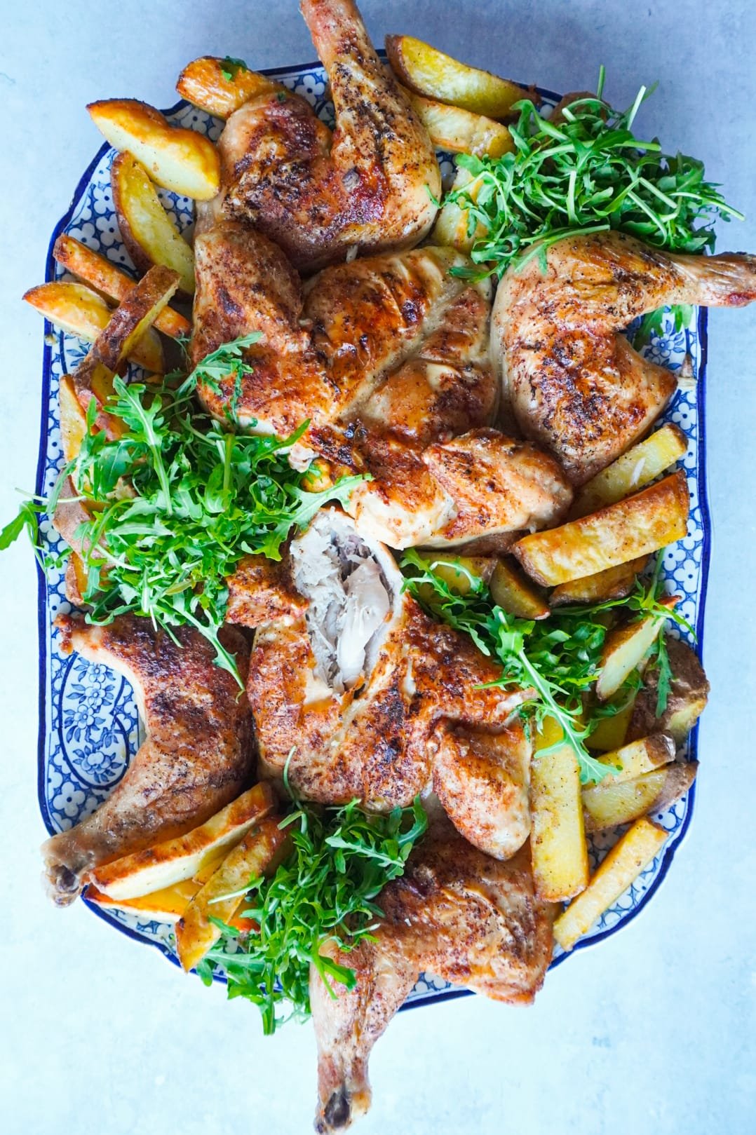 Golden Spatchcock Chicken served with potatoes and greens