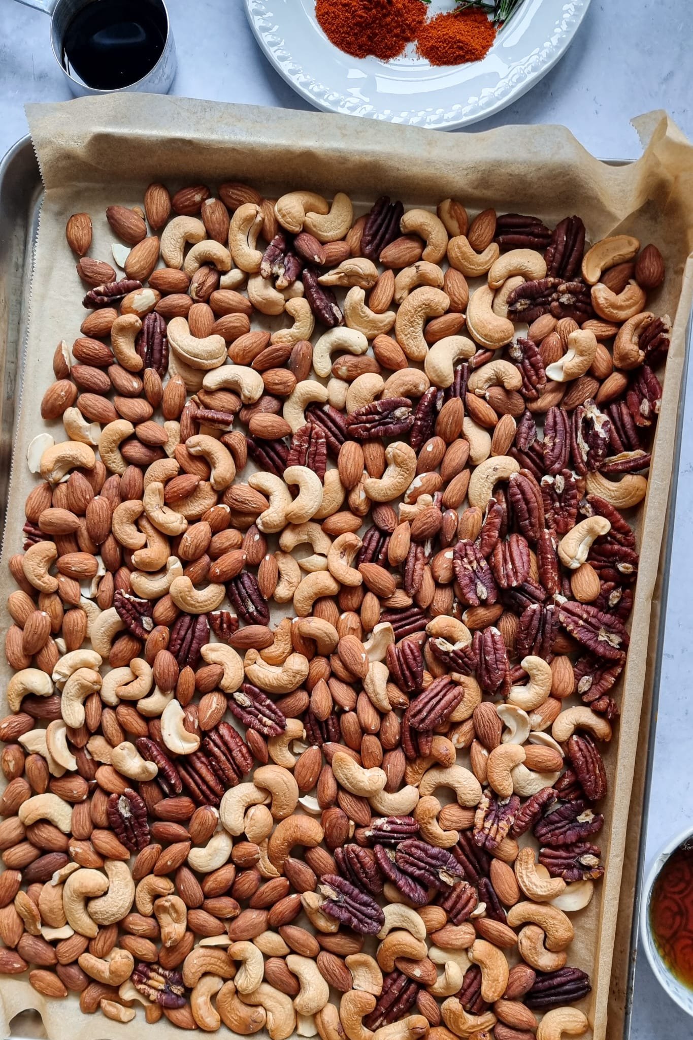 Roasted cashews, almonds and pecans in Sweet and Savoury Spiced Nuts And Pretzels recipe