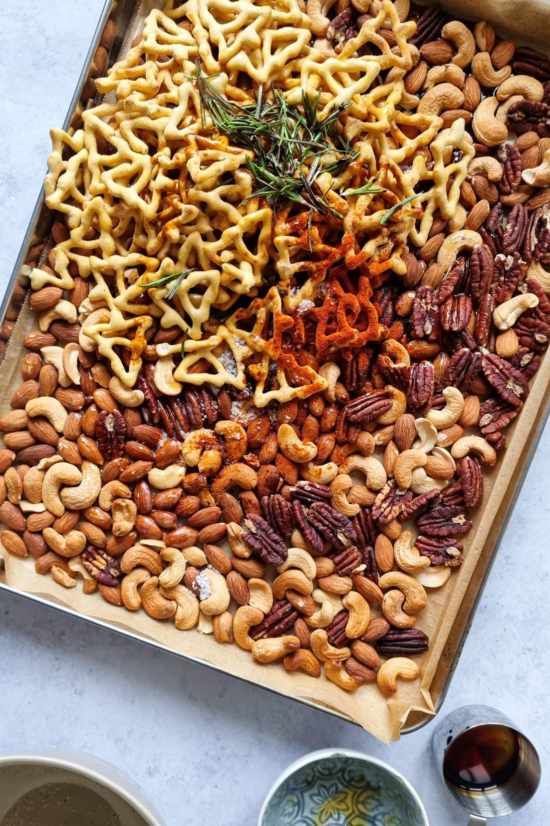 Adding the spices, sauces, and rosemary to the roasted nuts