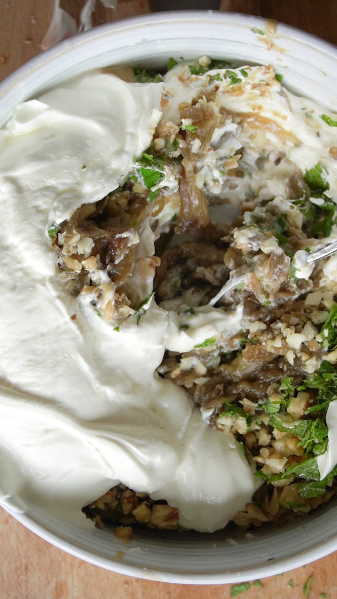 Add the tahini and yogurt and mix altogether really well - one step closer to making this Tahini Walnut Aubergine Dip with Crispy Butter Beans