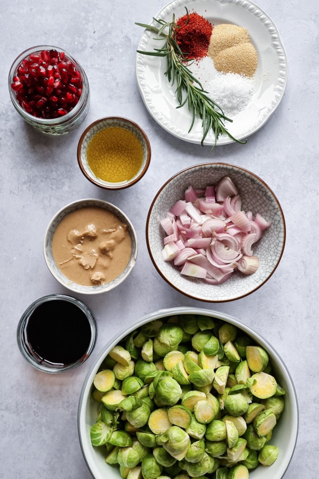 The ingredients needed to make Tahini and pomegranate brussels sprouts

