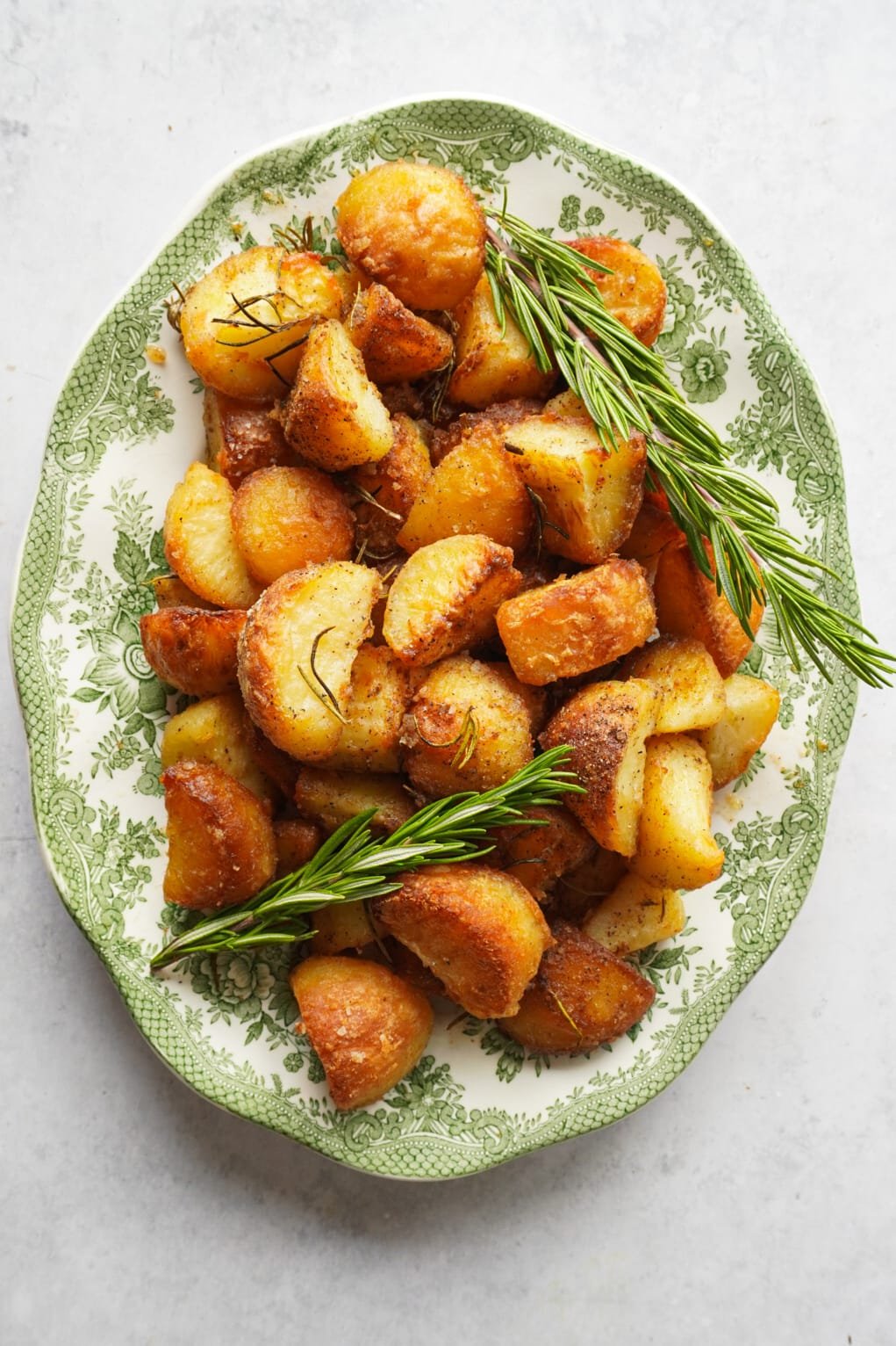 perfectly baked potato pieces that are golden and crispy with fresh rosemary