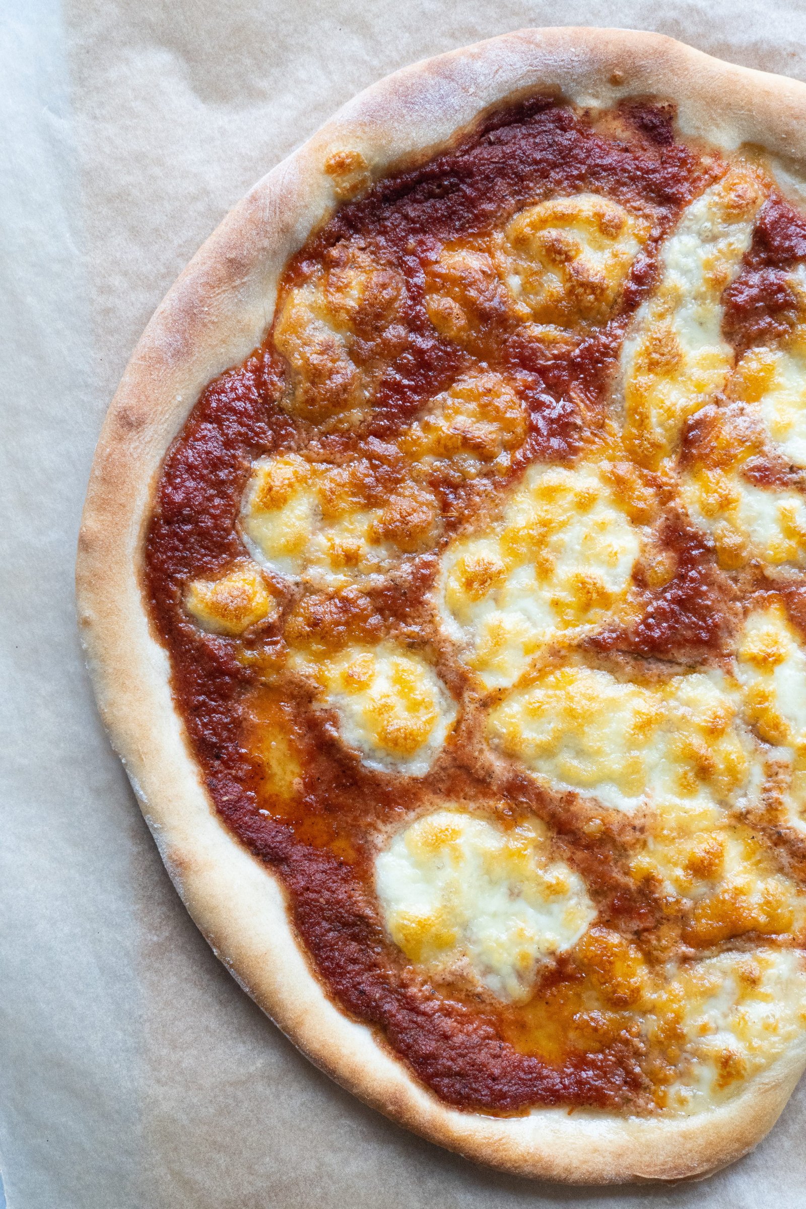 A golden brown pizza crust with the ideal texture, crispy on the outside and tender on the inside, the hallmark of a perfect homemade Italian pizza dough.