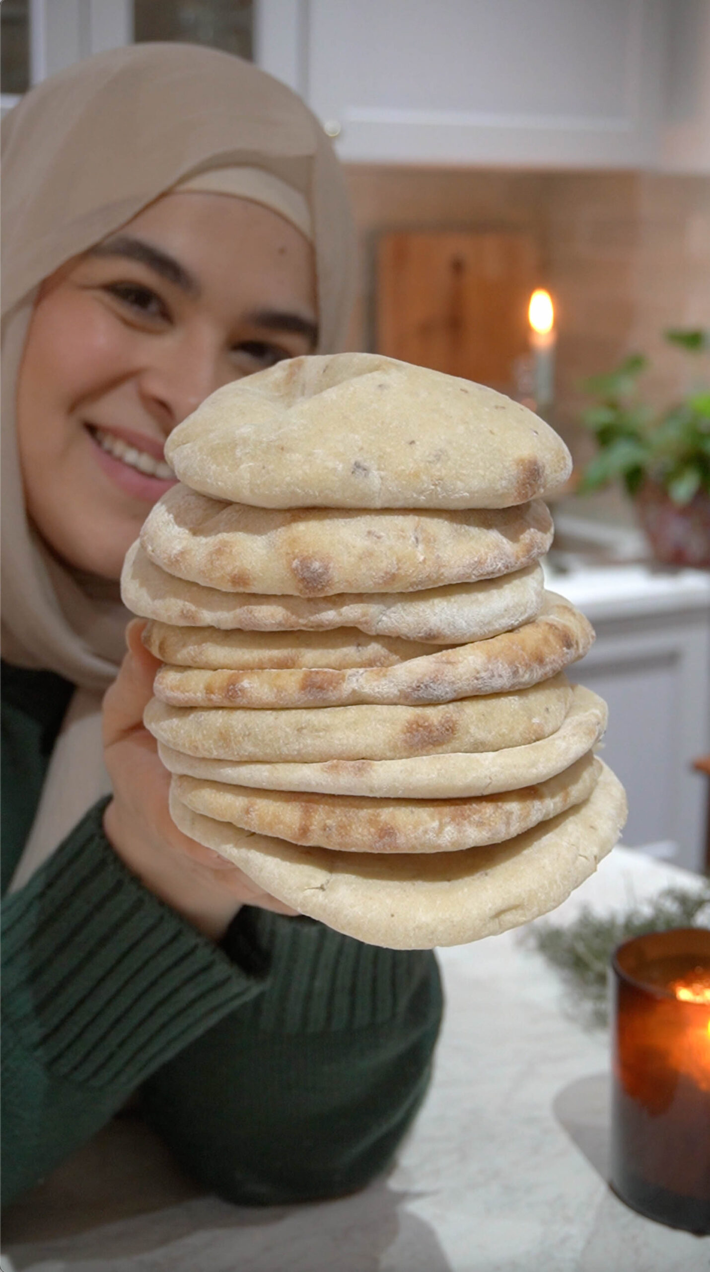 A stack of freshly baked Super Easy Sourdough Pita Bread, soft, fluffy, and slightly golden, ready to be served.